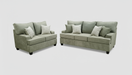 Sofa and loveseat set with toss pillows  in a furniture store setting