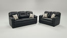 Black leather sofa set with patterned toss pillows on a gray background