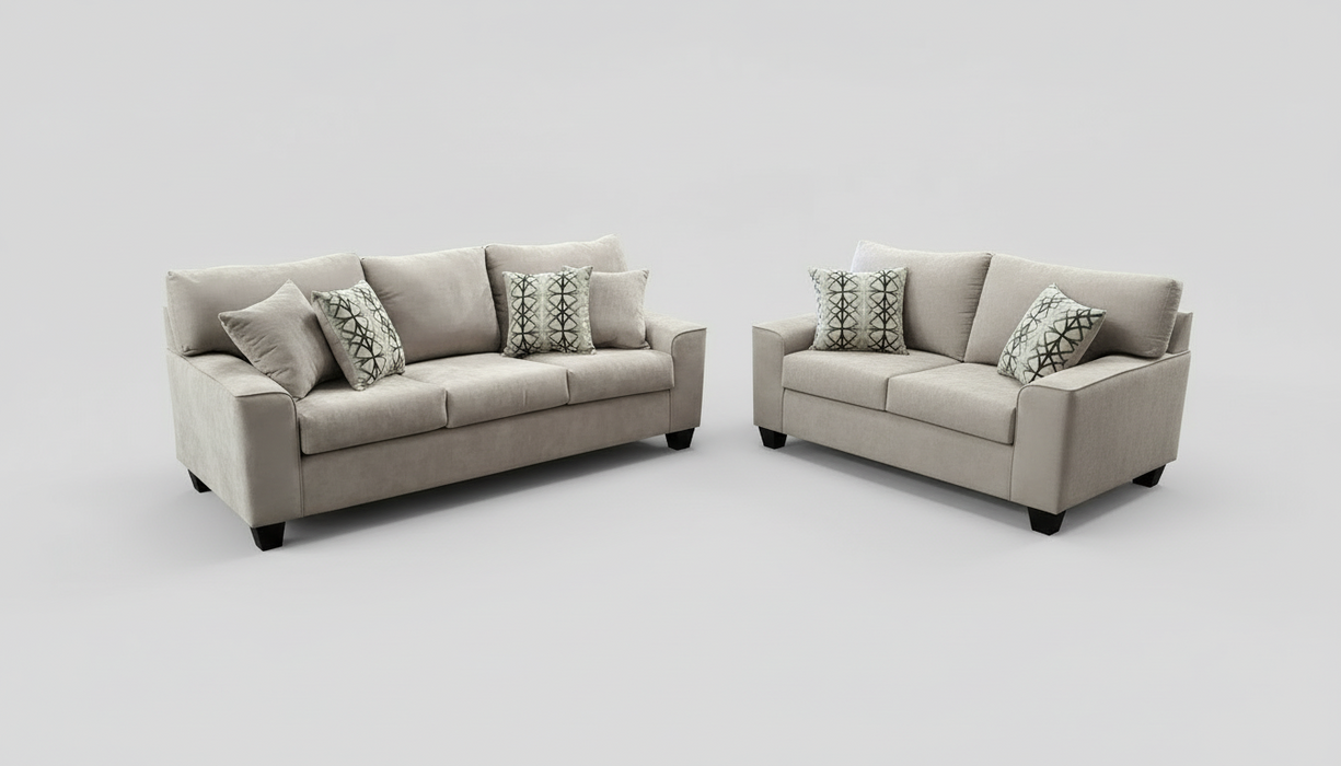 Sofa and Loveseat Set with decorative toss pillows in a furniture store setting