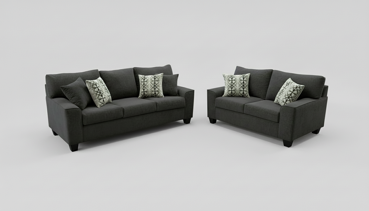 Gray sofa and loveseat set with patterned toss pillows on a light gray background