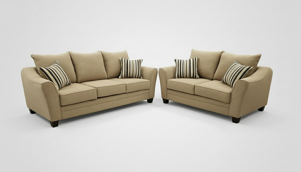 A sofa and loveseat set with striped toss pillows in a furniture store setting.