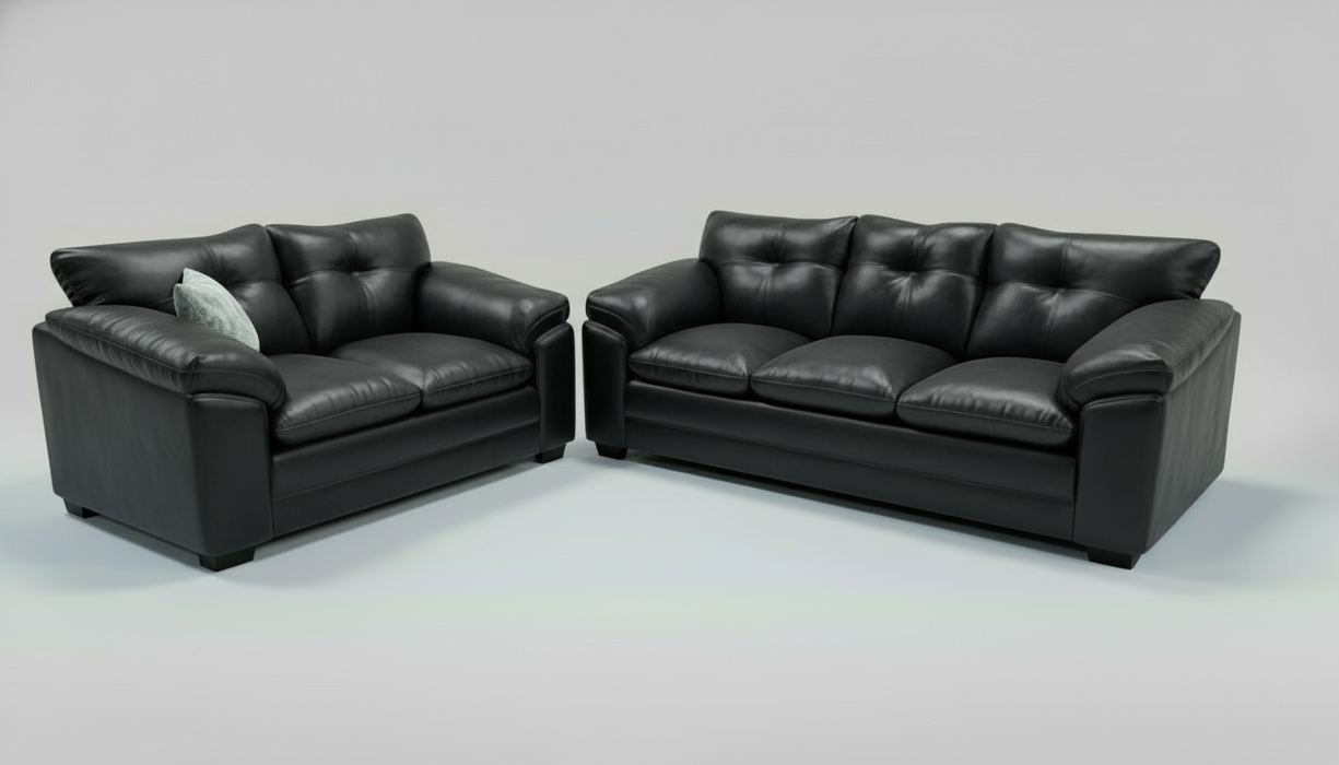 Blue sofa and loveseat set with patterned toss pillows on a white background